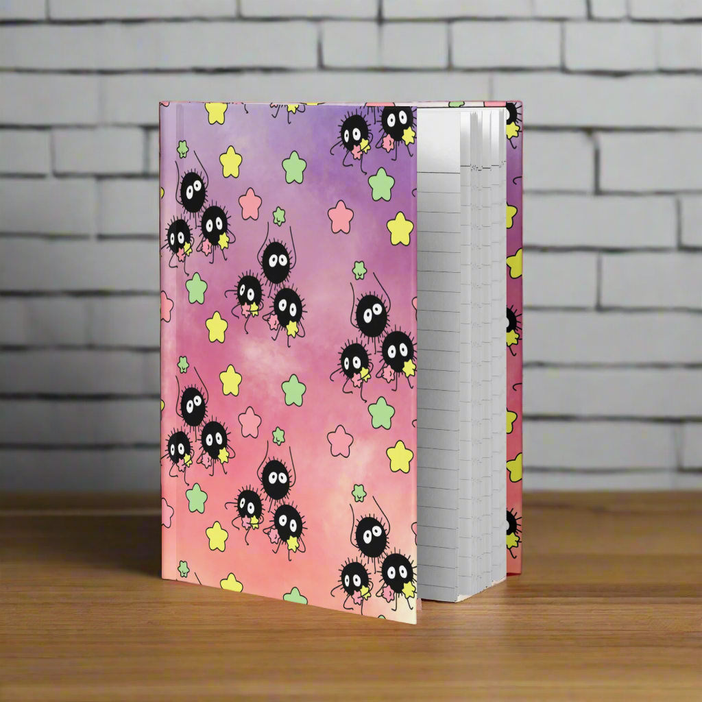 Notebook with a colorful design featuring cartoon characters and stars on a white background