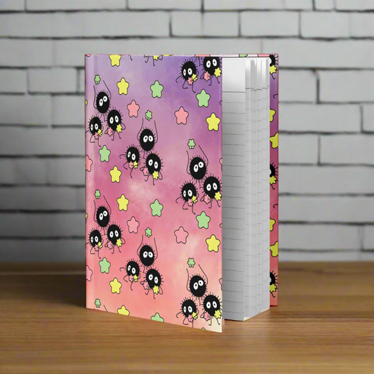 Notebook with a colorful design featuring cartoon characters and stars on a white background